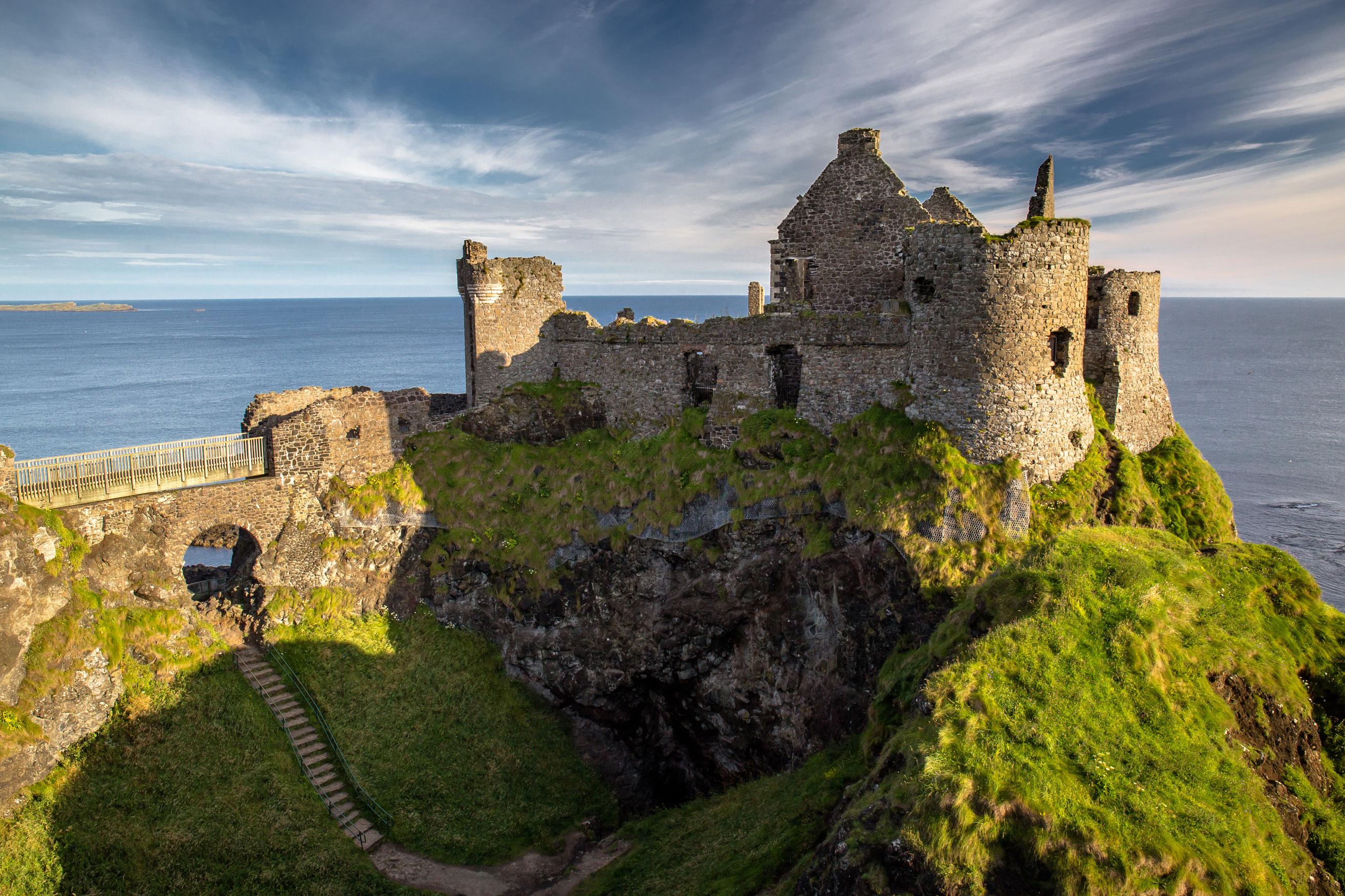 View of the ruins of Dunluce castle with an Ireland vacation package